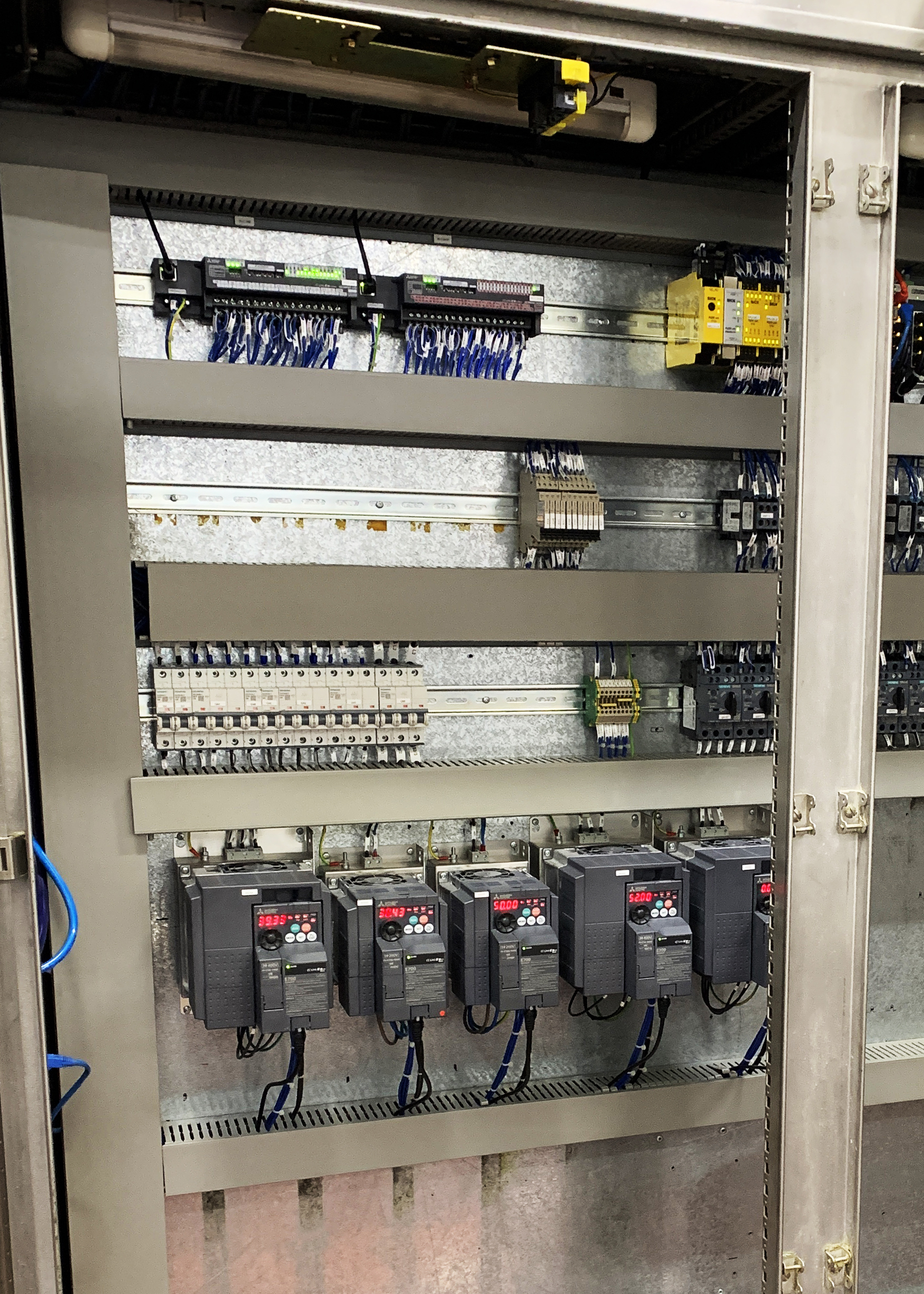 The new PLCs incorporate their own I/O modules, allowing Bakkavor Pizza to optimise their equipment footprint, saving panel space that could be used to host the new system’s inverters and servos. [Source: Control Freaks Ltd.]